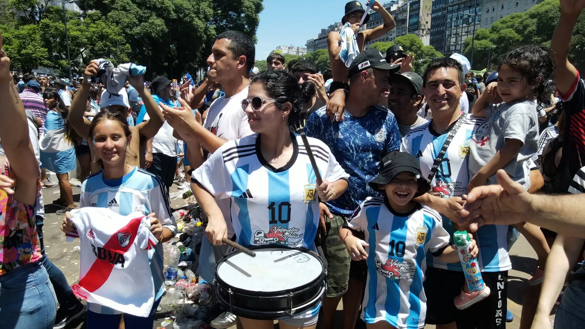 Soccer fans celebrate a game win with team jerseys and drums in Buenos Aires. 