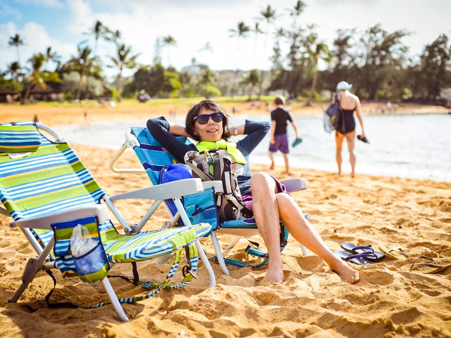 Woman relaxing on beach in Kauai.