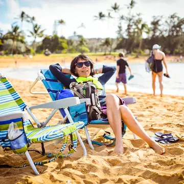 Woman relaxing on beach in Kauai.