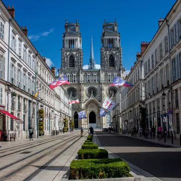 Orléans, France - August 17, 2018: Cathédrale Sainte-Croix rises up above Rue Jeanne d'Arc