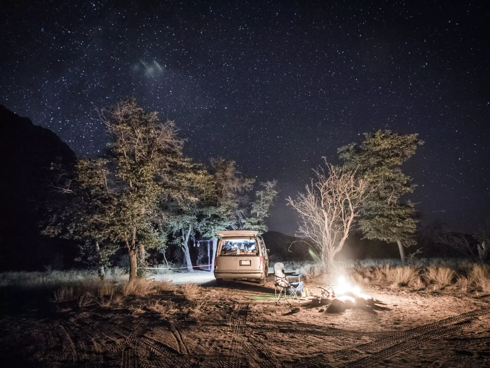 A campervan and fire under the stars at Cochise Stronghold camp in Arizona.
726772841
Arizona; Astronomy; AutotagHighlyAuthentic - Do Not Delete; Bare Tree; Camp; Campfire; Camping; Camping Chair; Cochise Stronghold; Color Image; Flame; Grass; Growth; Heat; Heat - Temperature; Horizontal; Illuminated; Illumination; Mode of Transport; Nature; Night; No People; Non-Urban Scene; Outdoor Chair; Outdoors; Photography; Scenics - Nature; Sky; Space and Astronomy; Star; Star - Space; Tranquility; Transportation; Tree; USA; Van;