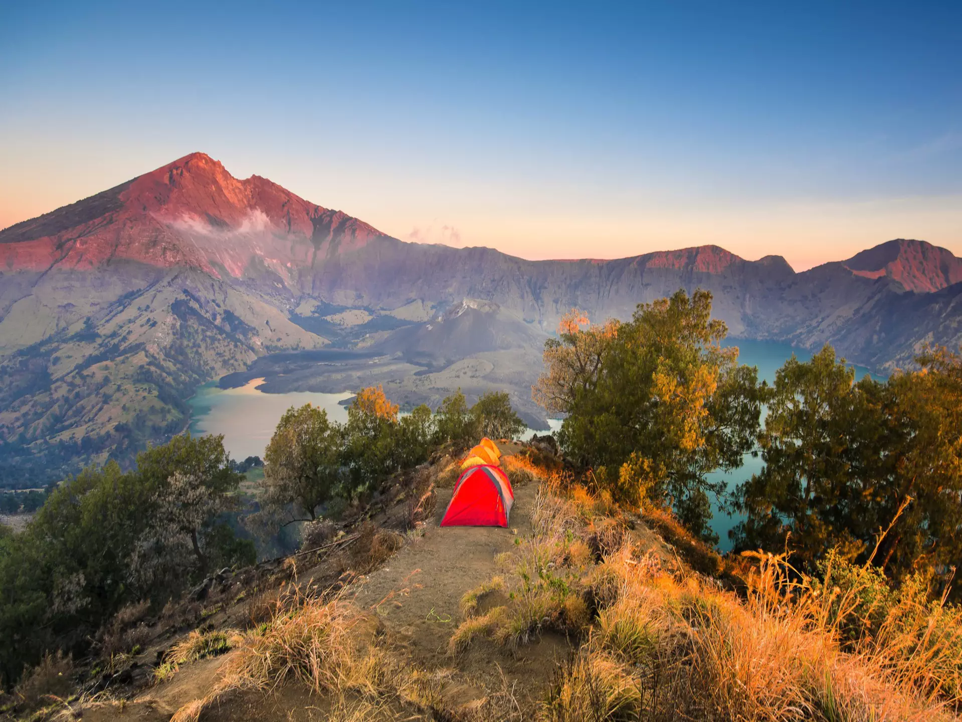 Tents pitched on the mountainous Senaru rim with Mount Rinjani (Anak Rinjani) in the background.
1286657365
adventure, asia, background, base camp, beautiful, blue, camp, campsite, century, cloud, crater, forest, green, gunung, hiking, hill, indonesia, island, lake, landscape, lombok, mount, mountain, national, nature, outdoor, park, picture, plawangan, rim, rinjani, scenic, season, senaru, sky, sport, summer, sunrise, sunset, tent, top, tourism, travel, tree, trekking, tropical, view, volcano, water, wilderness