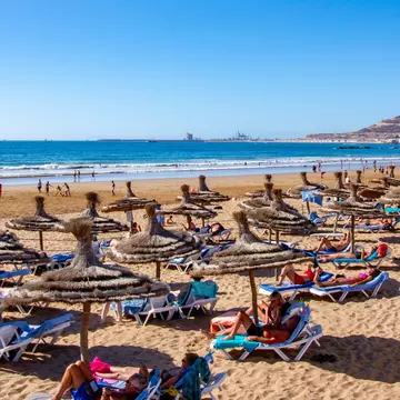 Sunseekers enjoying the city beach at Agadir. Gilles Rivest/Shutterstock