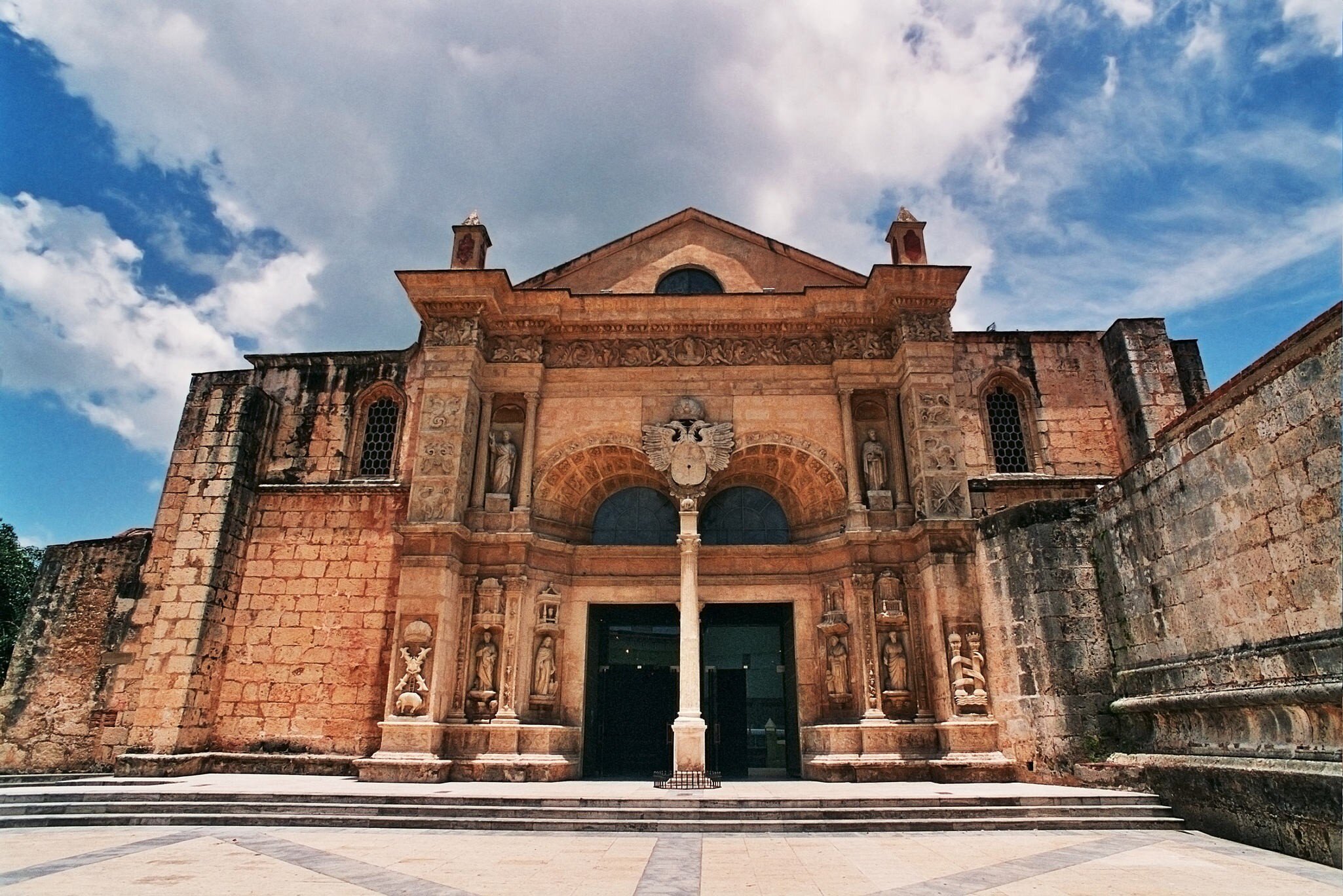 Cathedral Basilica Menor de Santa Maria, Primada AmericaThe oldest church in the Americas. Diego Columbus, son of Christopher Columbus, set the first stone of the cathedral in 1514. One of the main tourist attractions in the Dominican Republic.
The Past History Architecture Travel Destinations Horizontal Outdoors Low Angle View Place of Worship Statue Cathedral Famous Place Sky Cloud - Sky Day Dominican Republic Sunlight Arch Christianity Steps Entrance Color Image No People Photography Latin America Human Representation Santo Domingo - Dominican Republic