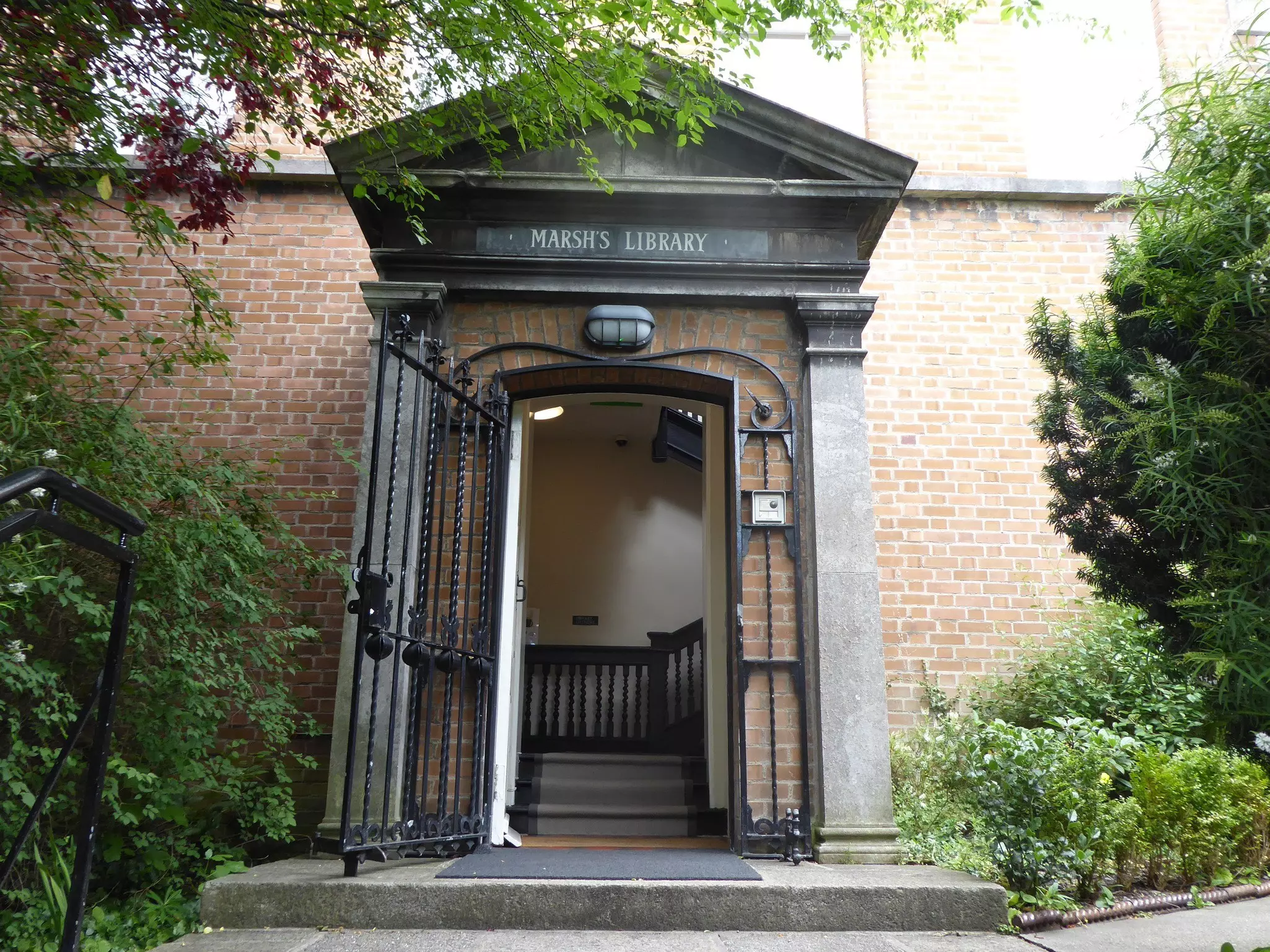 A portico entranceway to a brick building.