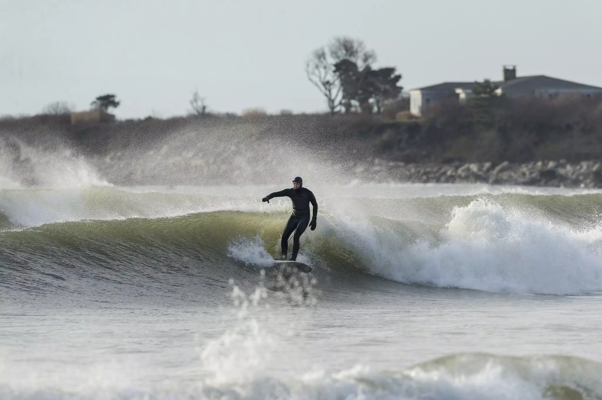 Surfer on middle wave in a set at Goosewing Beach Rhode Island
