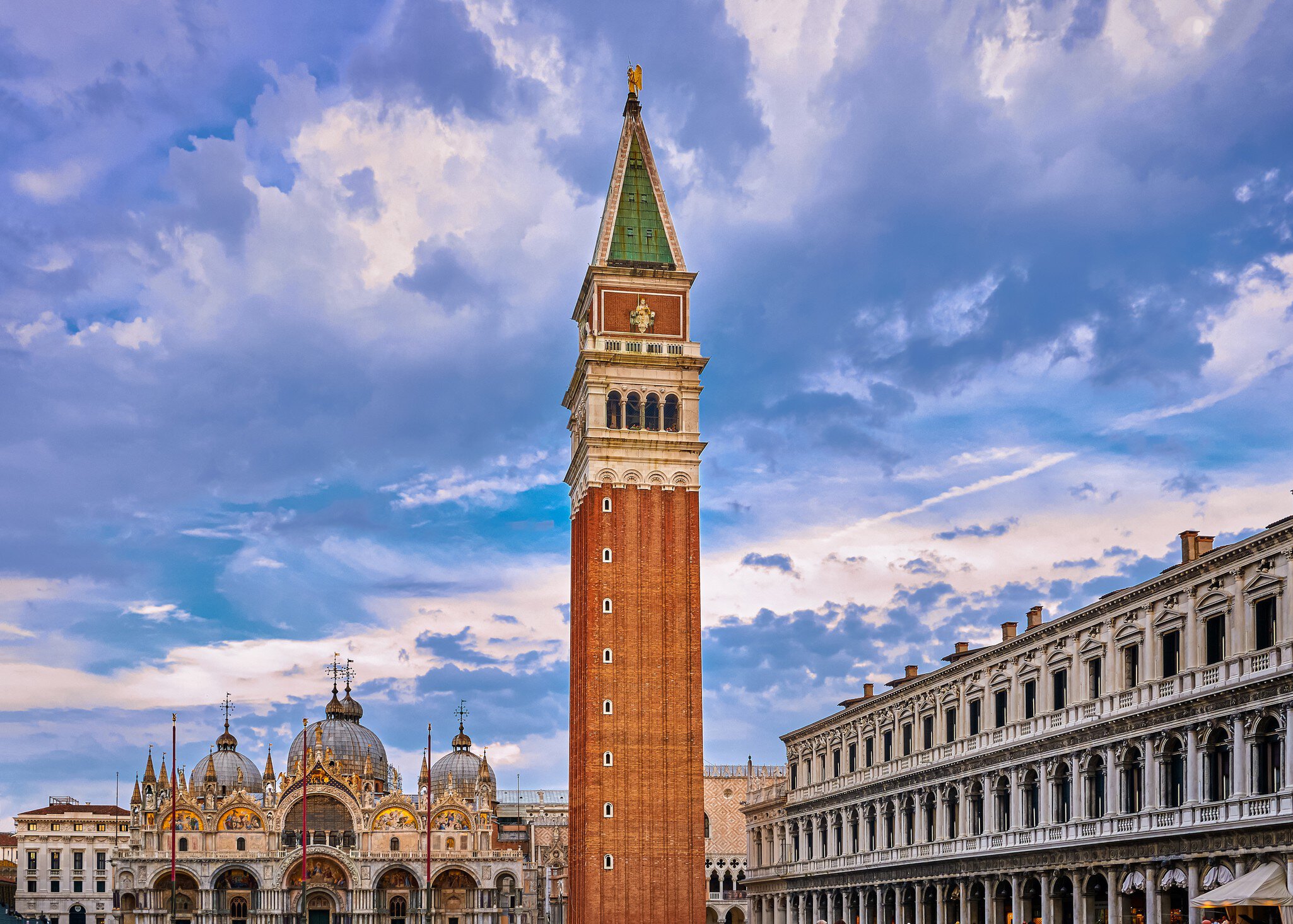 View of St Mark's square or piazza di San Marco, Venice, Italy in sundown on cloudy day. Campanile, St Mark's Basilica, Procurate Vecchie building