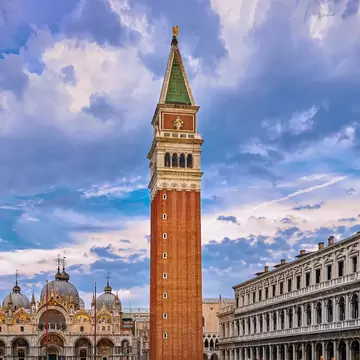 View of St Mark's square or piazza di San Marco, Venice, Italy in sundown on cloudy day. Campanile, St Mark's Basilica, Procurate Vecchie building