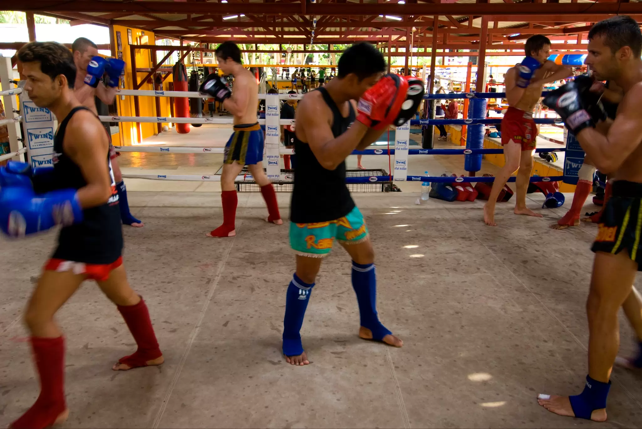 Tourists working out at a Thai boxing gym in Thailand.