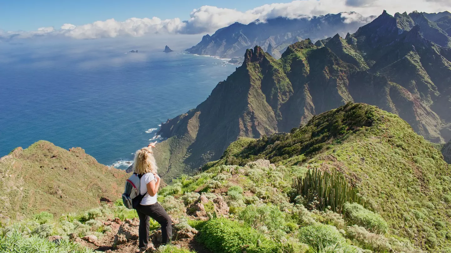 Woman hiker watching beautiful costal scenery in the Anaga region on Tenerife