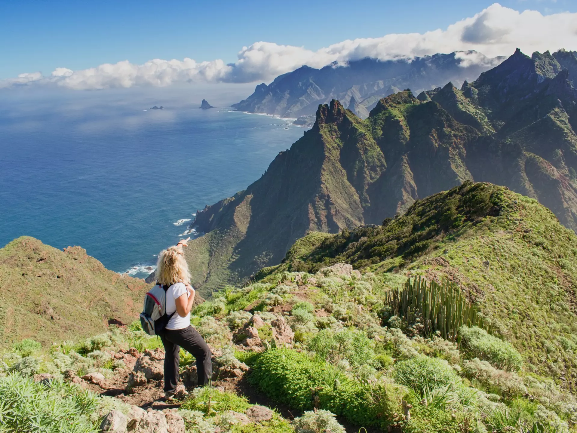 Woman hiker watching beautiful costal scenery in the Anaga region on Tenerife