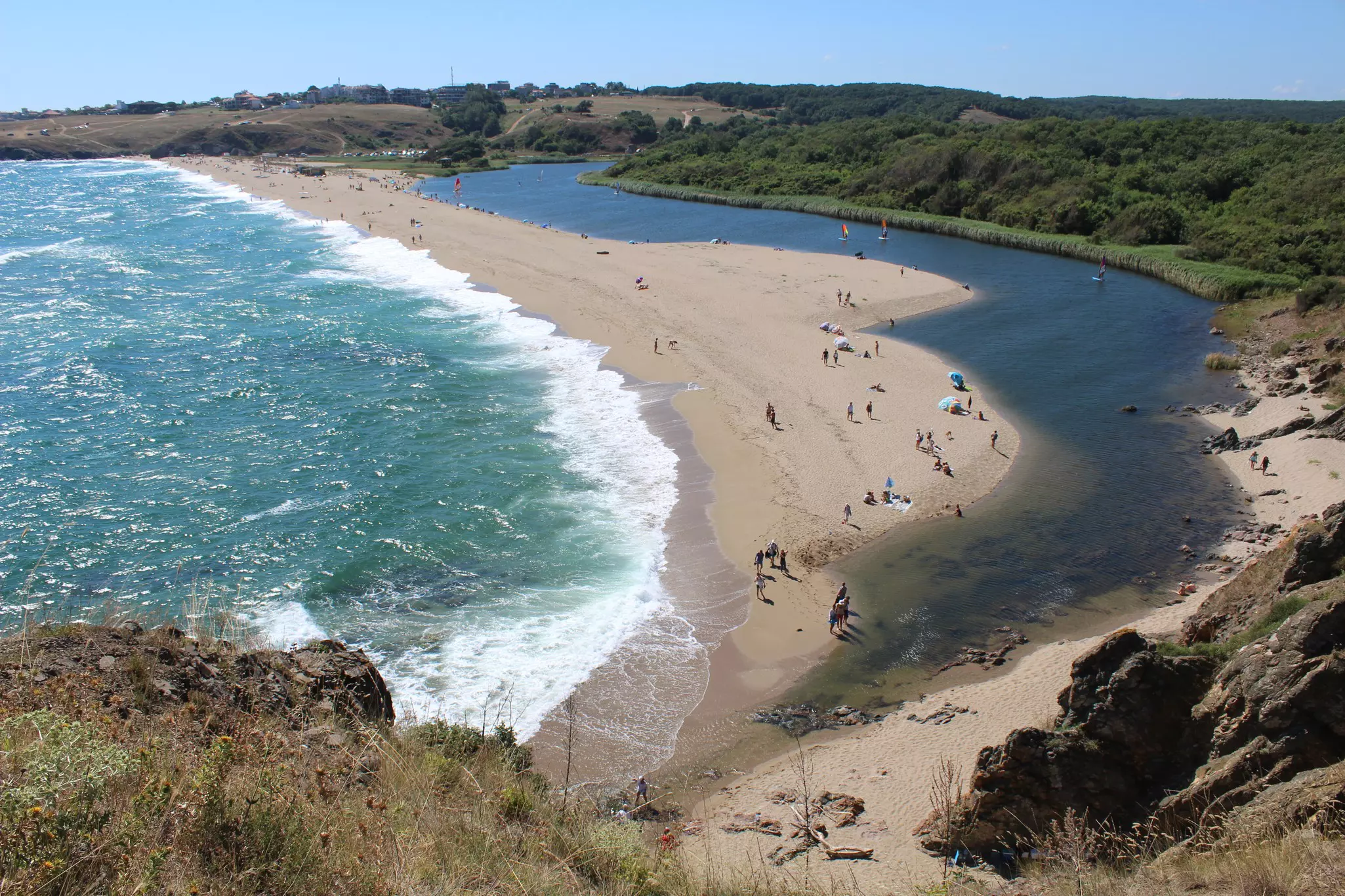 A small number of people enjoying the sunshine on Lipite Beach.