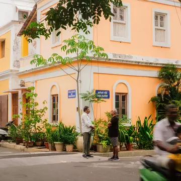 The tall towers of a temple are covered in elaborate multicolored sculptures.