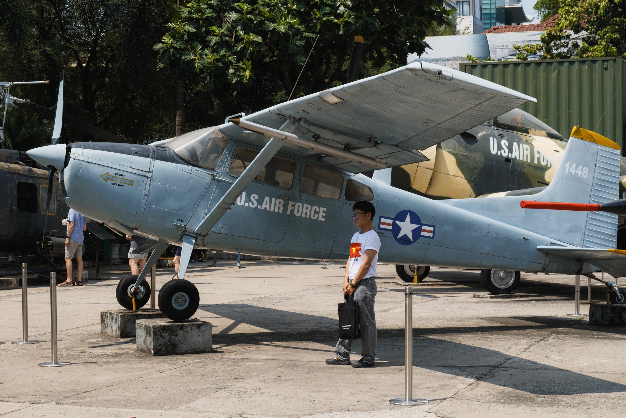 A US Air Force propeller aircraft on outdoor display, visitors walking past.