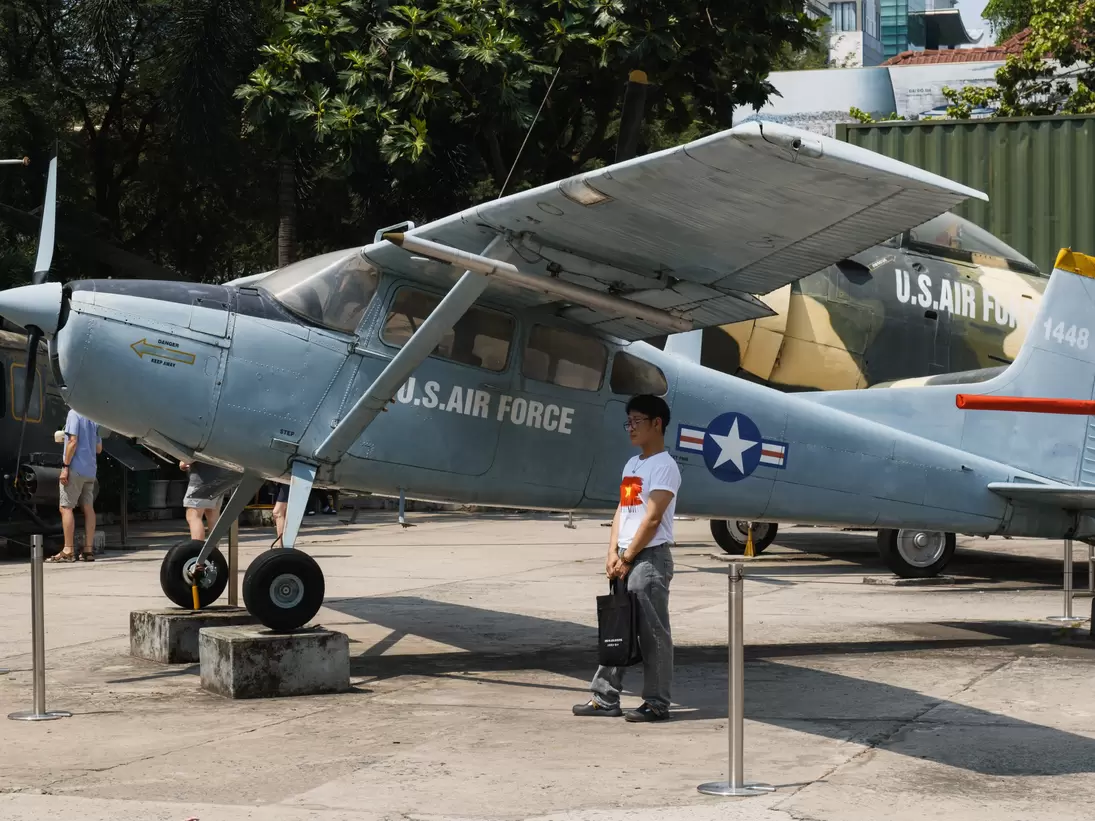A US Air Force propeller aircraft on outdoor display, visitors walking past.