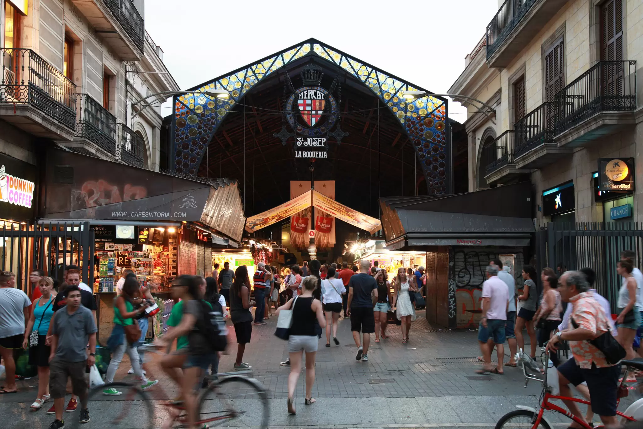 People walking near the entrance to La Boqueria, a marketplace located off La Rambla.