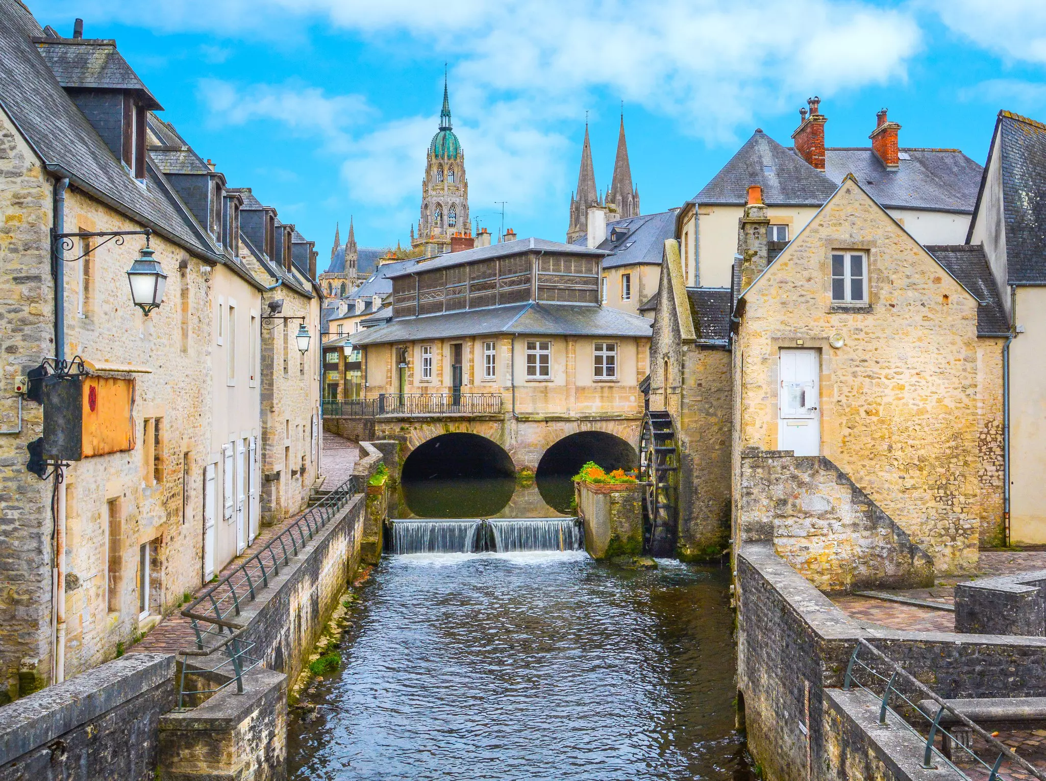 Scenic view in Bayeux, Normandy, featuring a small body of water with charming buildings on three sides