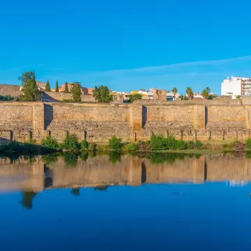 View of the walls of the Alcazaba fortress by the Río Guadiana in Mérida, Spain.