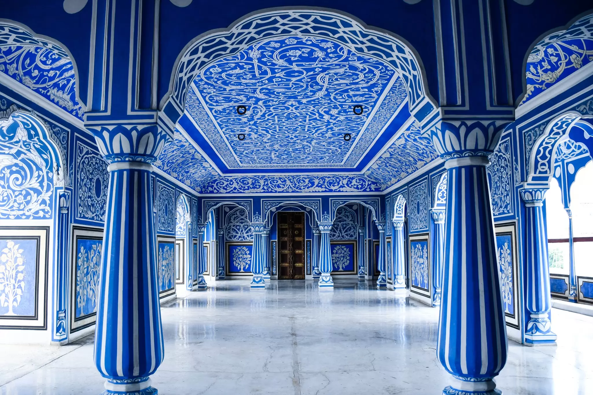 View of an ornamental blue room inside the Jaipur City Palace in India.