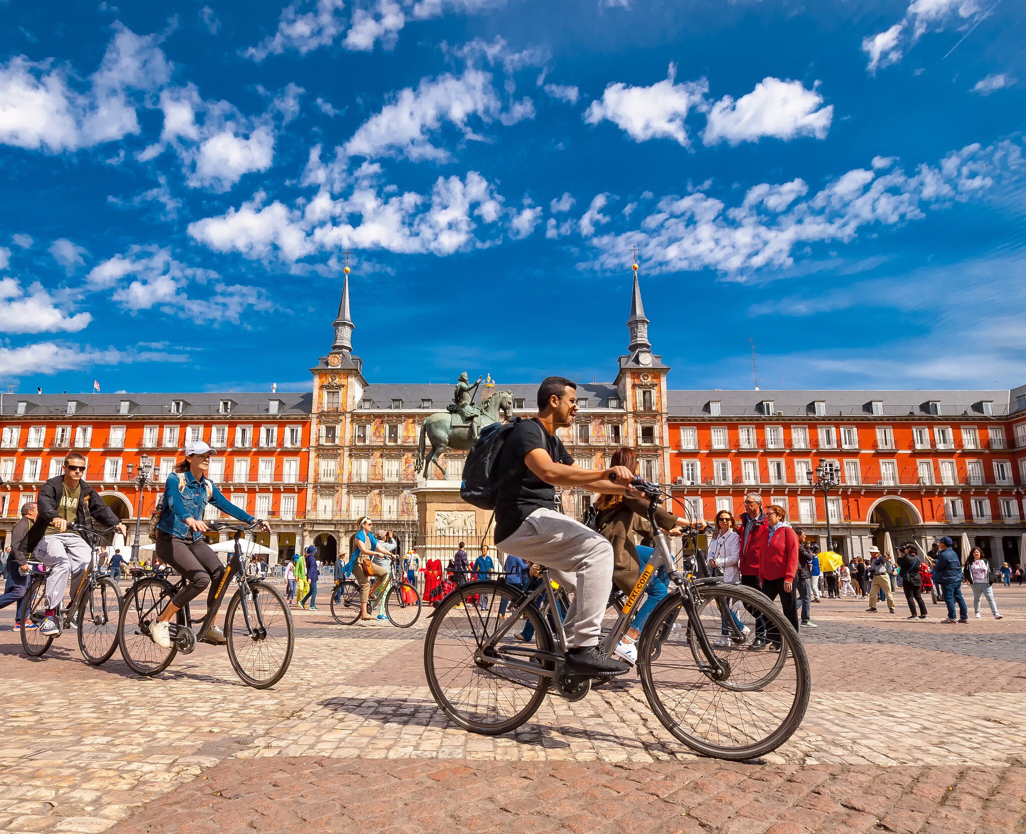 Spain, Madrid..A view of  La Plaza Mayor square in Madrid where there were a group of tourists riding bicycles. The Plaza Mayor square is one of the most famous squares in the town and located in the city center. People walk and cycle through the str…