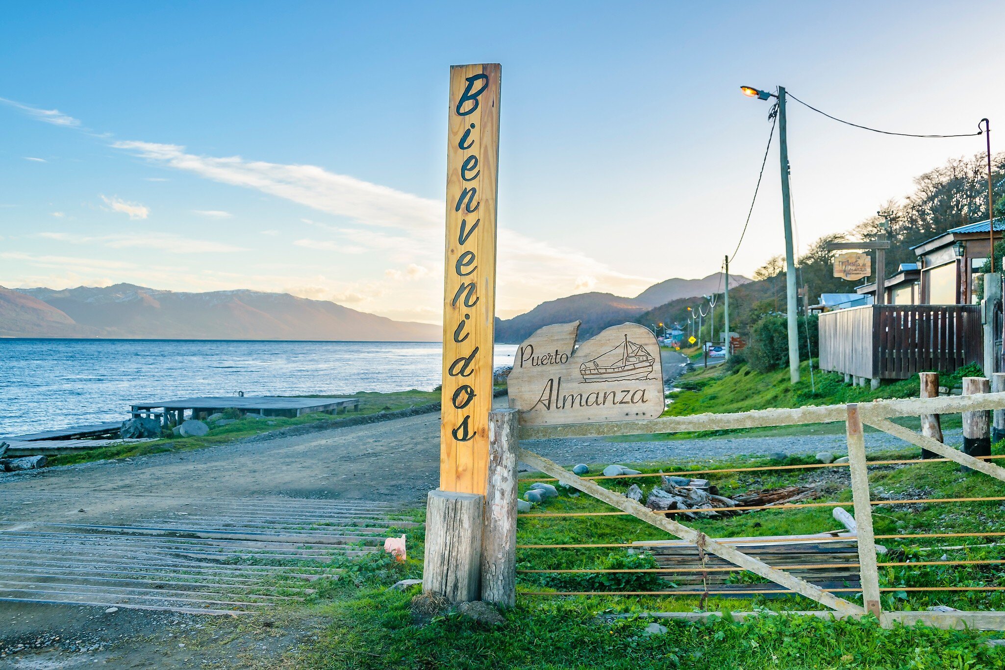 Waterfront houses at dirt road path in Puerto Almanza, Tierra del Fuego, Argentina.