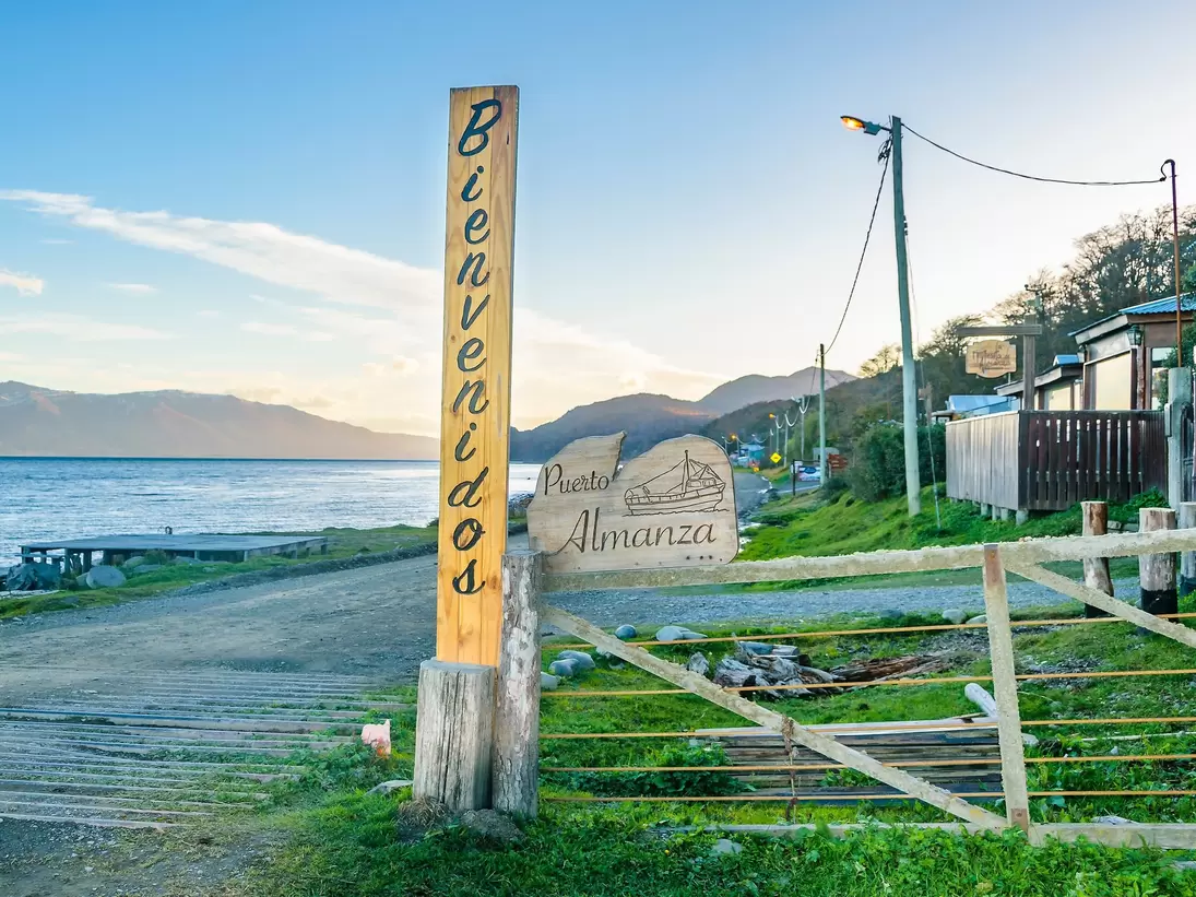 Waterfront houses at dirt road path in Puerto Almanza, Tierra del Fuego, Argentina.