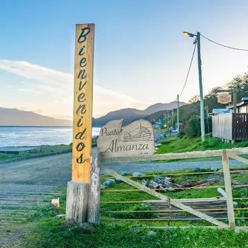Waterfront houses at dirt road path in Puerto Almanza, Tierra del Fuego, Argentina.