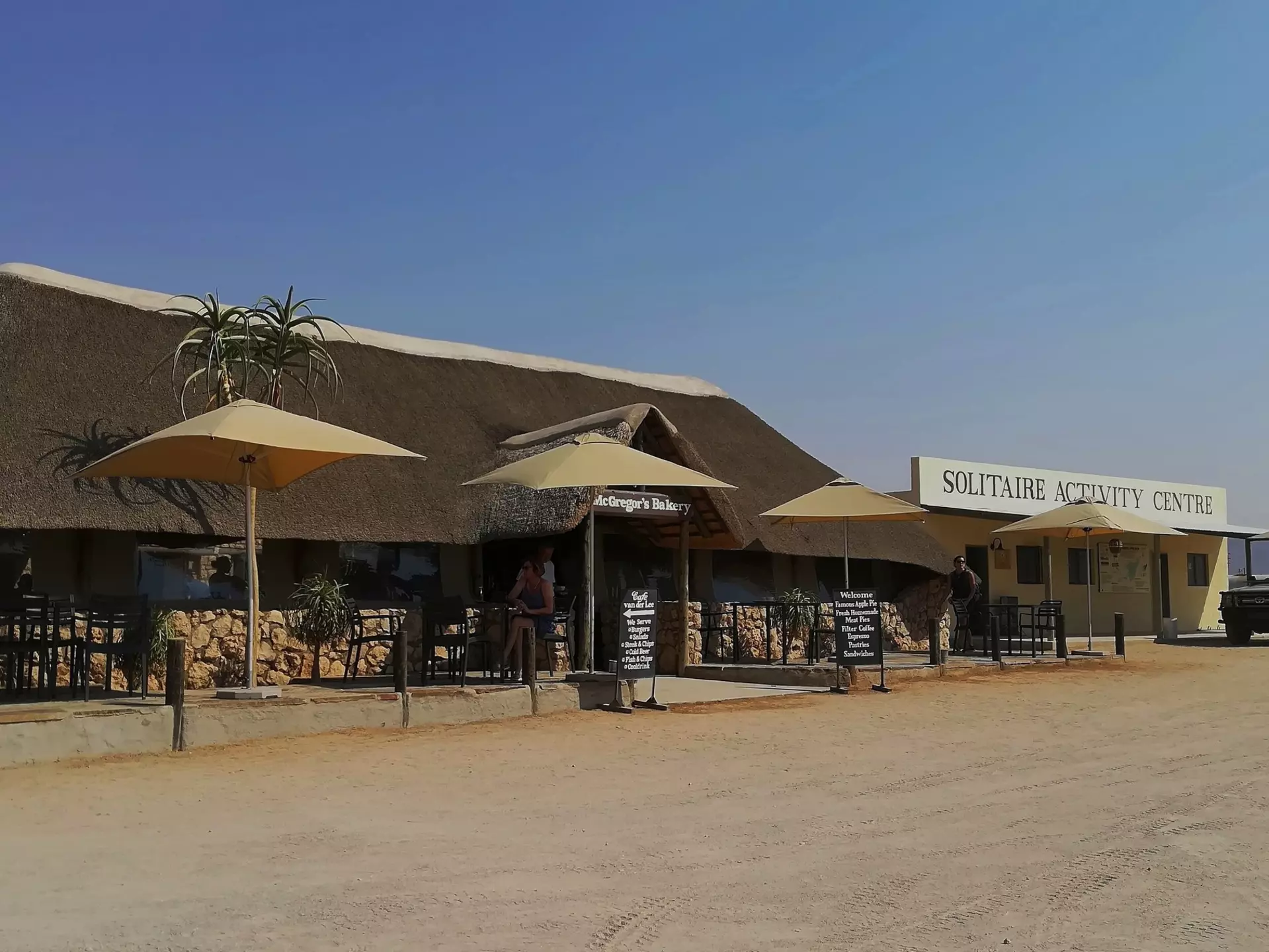 Solitaire, Namibia - September 17, 2019: McGregor’s Bakery in Solitaire, famous for its apple pie, with thatched roofing, outdoor seating, and a desert backdrop, attracting road-tripping travelers, License Type: media, Download Time: 2025-10-27T17:14:51.000Z, User: katelyn.perry_lonelyplanet, Editorial: true, purchase_order: 65050 - Digital Destinations and Articles, job: wip, client: wip, other: Katelyn Perry