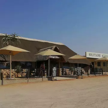 Solitaire, Namibia - September 17, 2019: McGregor’s Bakery in Solitaire, famous for its apple pie, with thatched roofing, outdoor seating, and a desert backdrop, attracting road-tripping travelers, License Type: media, Download Time: 2025-10-27T17:14:51.000Z, User: katelyn.perry_lonelyplanet, Editorial: true, purchase_order: 65050 - Digital Destinations and Articles, job: wip, client: wip, other: Katelyn Perry