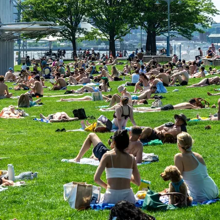Throngs of visitors on the lawn at the Christopher Street Pier in Hudson River Park in New York