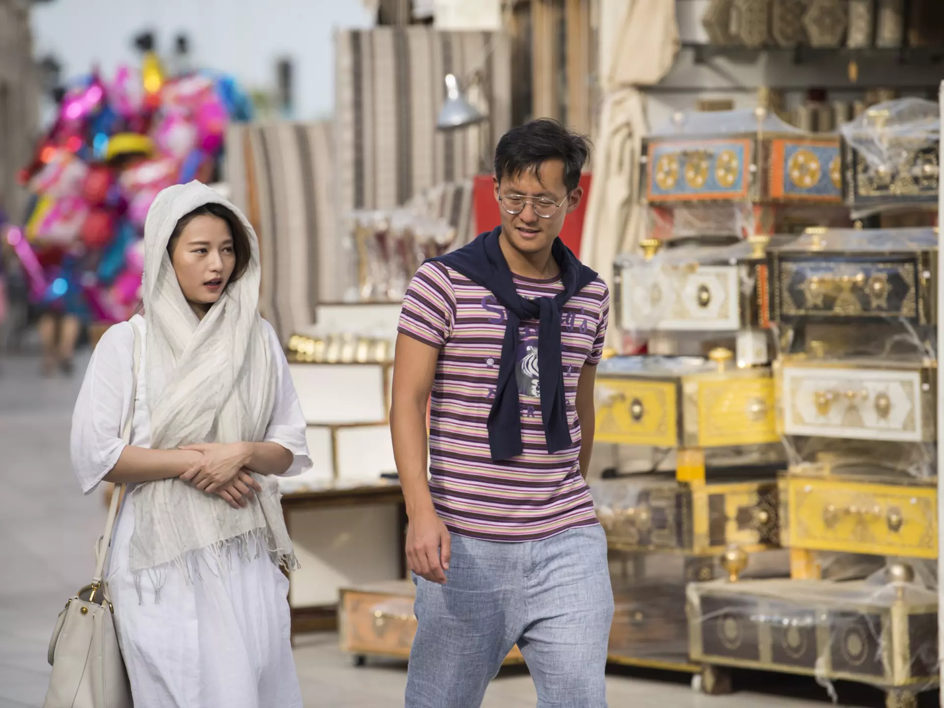Tourists tour the old market of Souk Waqif, Doha, Qatar, Middle East