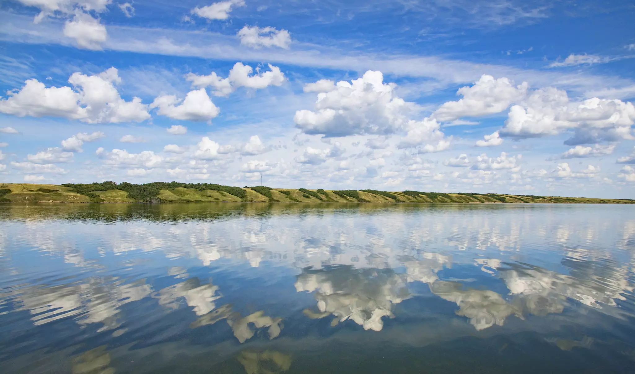 View of clouds reflected in Little Manitou Lake, Saskatchewan, Canada.