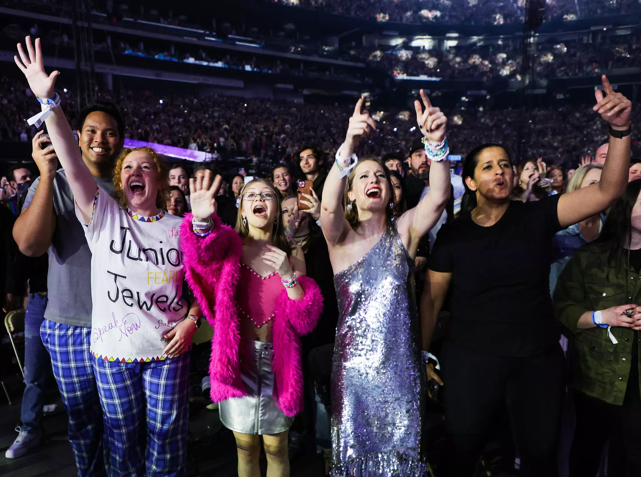  Fans react to Taylor Swift's performance onstage during the