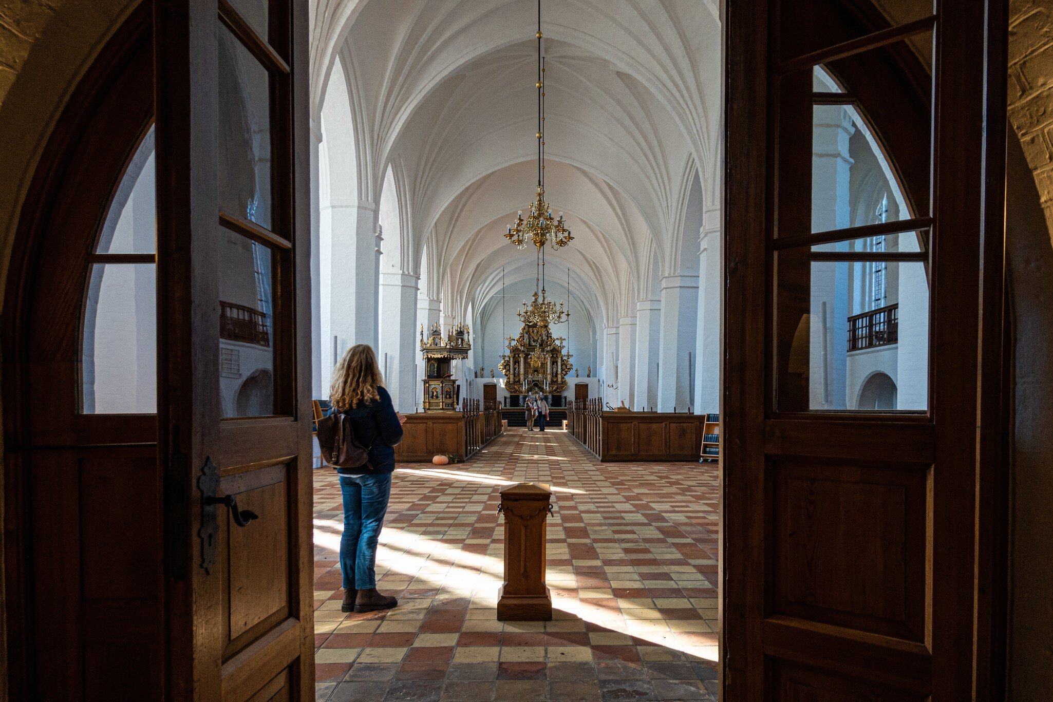 Maribo, Denmark. A woman stands in the entrance to the  Maribo Cathedral.