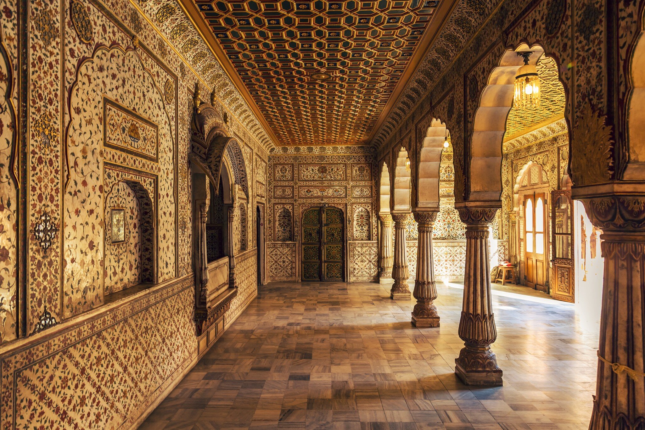 Junagarh Fort view of the Private Audience Hall in Anup Mahal with intricate gold artwork and columned structure. 