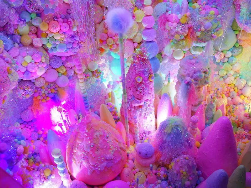 An art installation of bubbles, glitter and shapes in pastel colors, predominantly pink