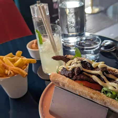 A steak ciabatta with fries and a mint lemonade