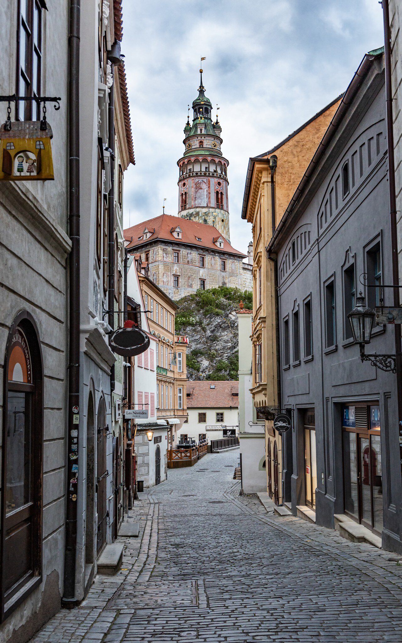 Cesky Krumlov, Czech Republic. View of the Tower of the Krumlov castle from narrow street in the city center. 