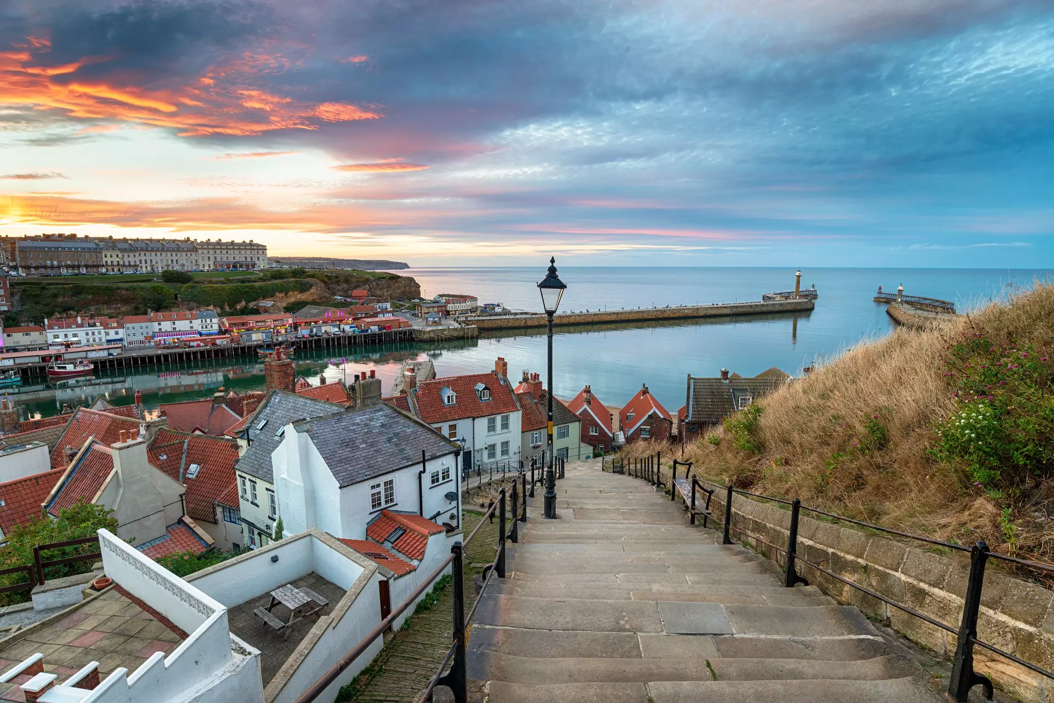 Stunning sunset over the 199 Steps leading down to Whitby harbour on the Yorkshire coast  