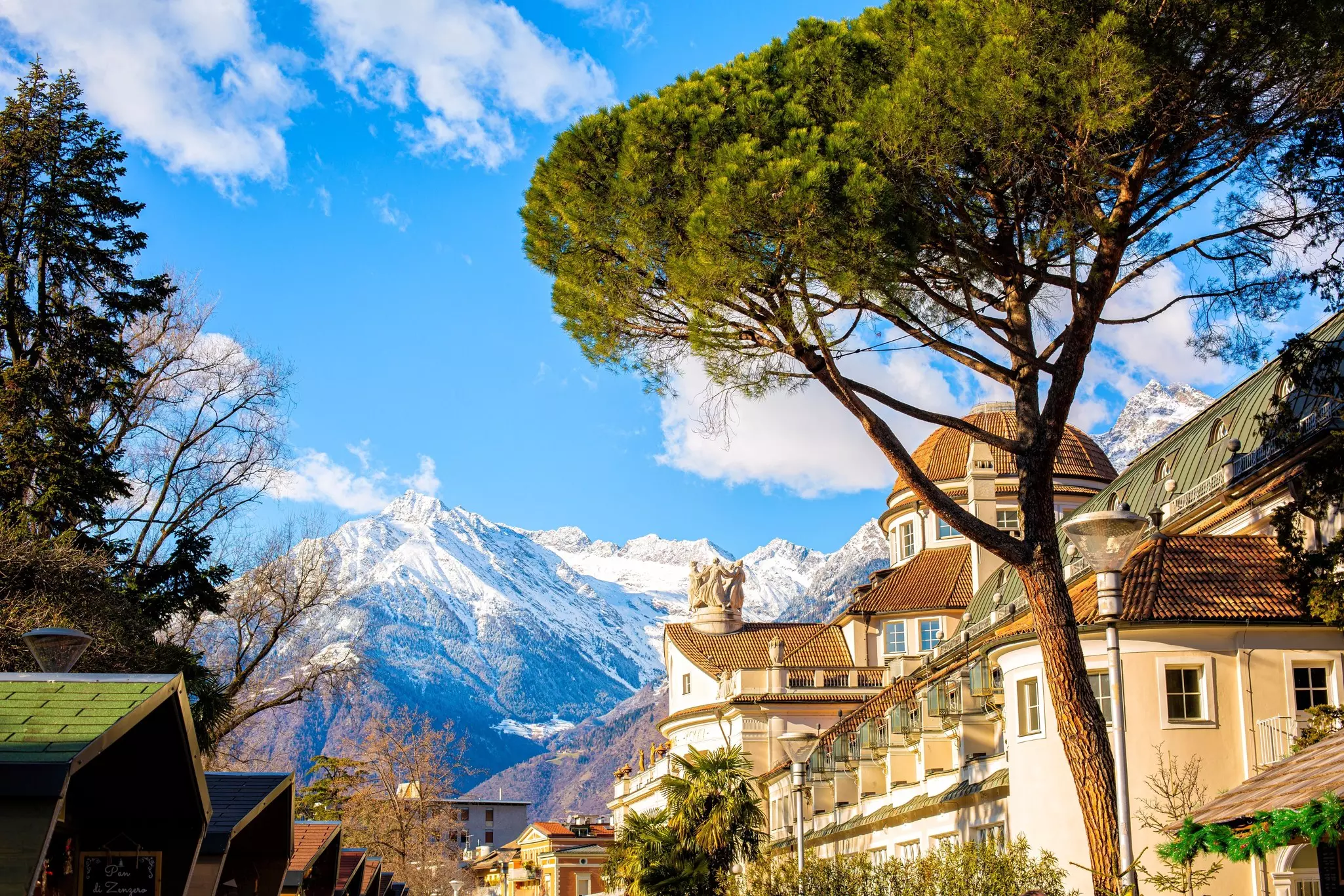 Snow-covered mountain peaks above a town bathed in sunshine on a winter's day.
