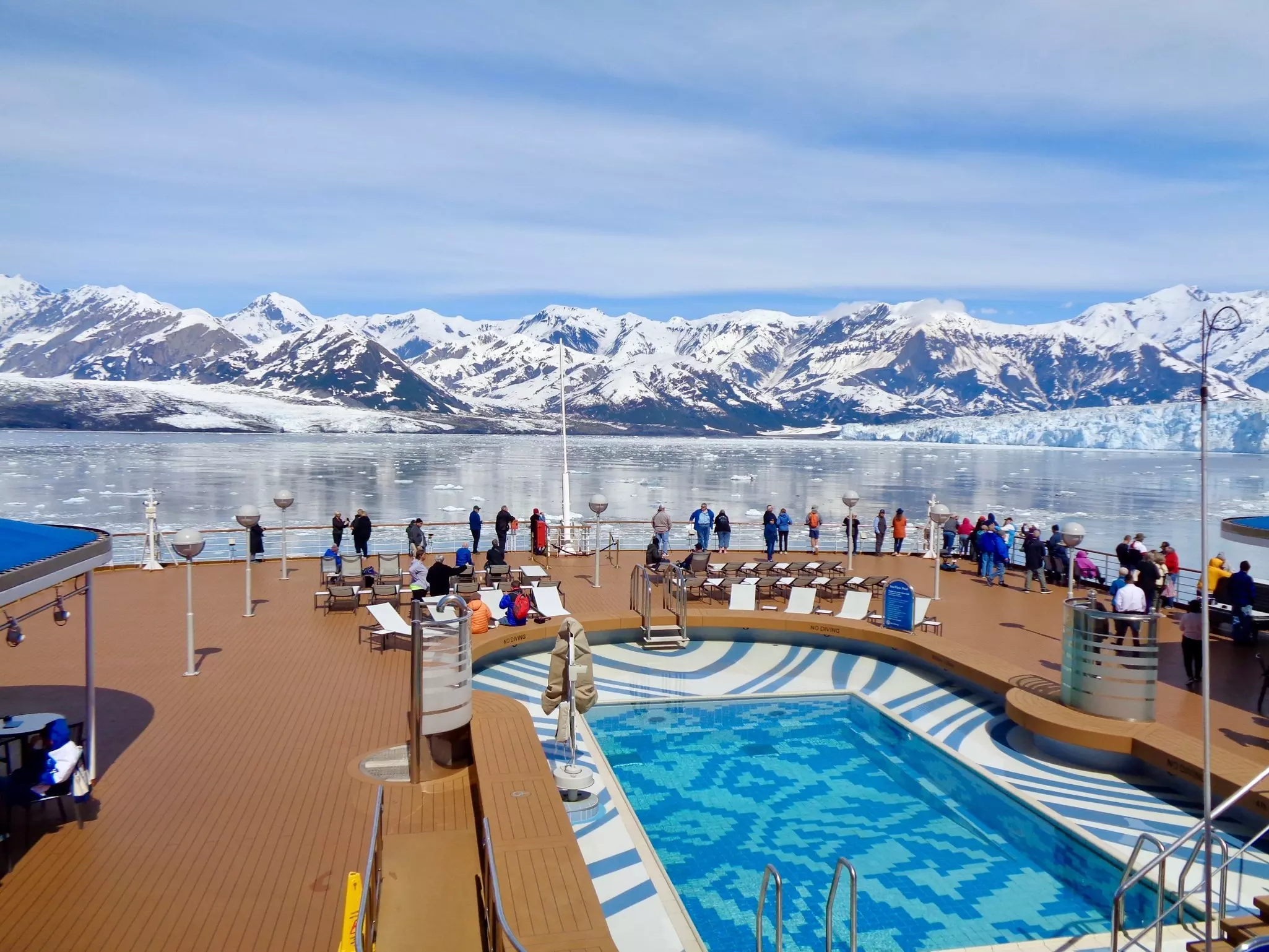 People onboard a cruise ship admiring the Hubbard Glacier off the coast of Yakutat, Alaska. 