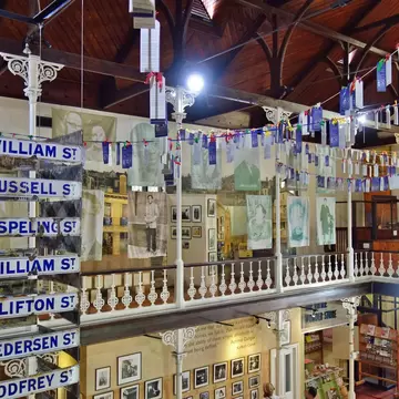 Exhibits of photos, ribbons and street signs in a museum