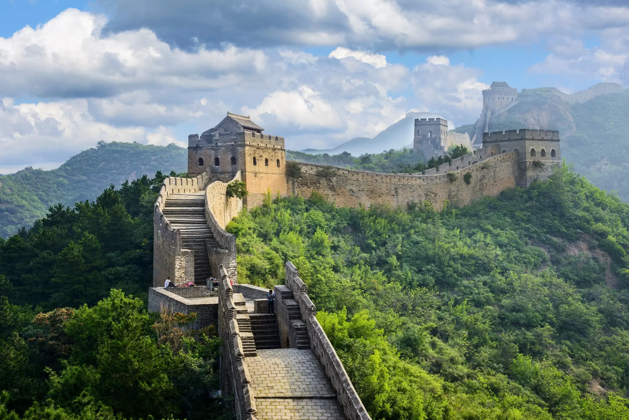Aerial view of the Great Wall of China at Badaling, surrounded by greenery.