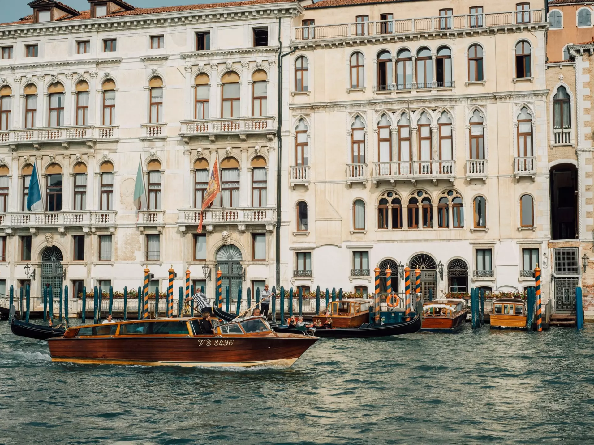 A water taxi cruises along the canal in Venice. Cheungjoproduction/Shutterstock