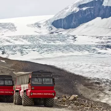 View of Ice Explorers, trucks designed for glacial travel, at Athabasca Glacier in the Columbia Icefields, Canada.