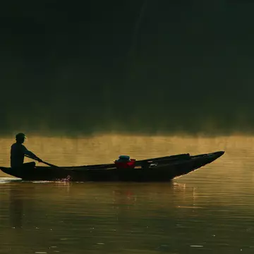 Boatman on water.