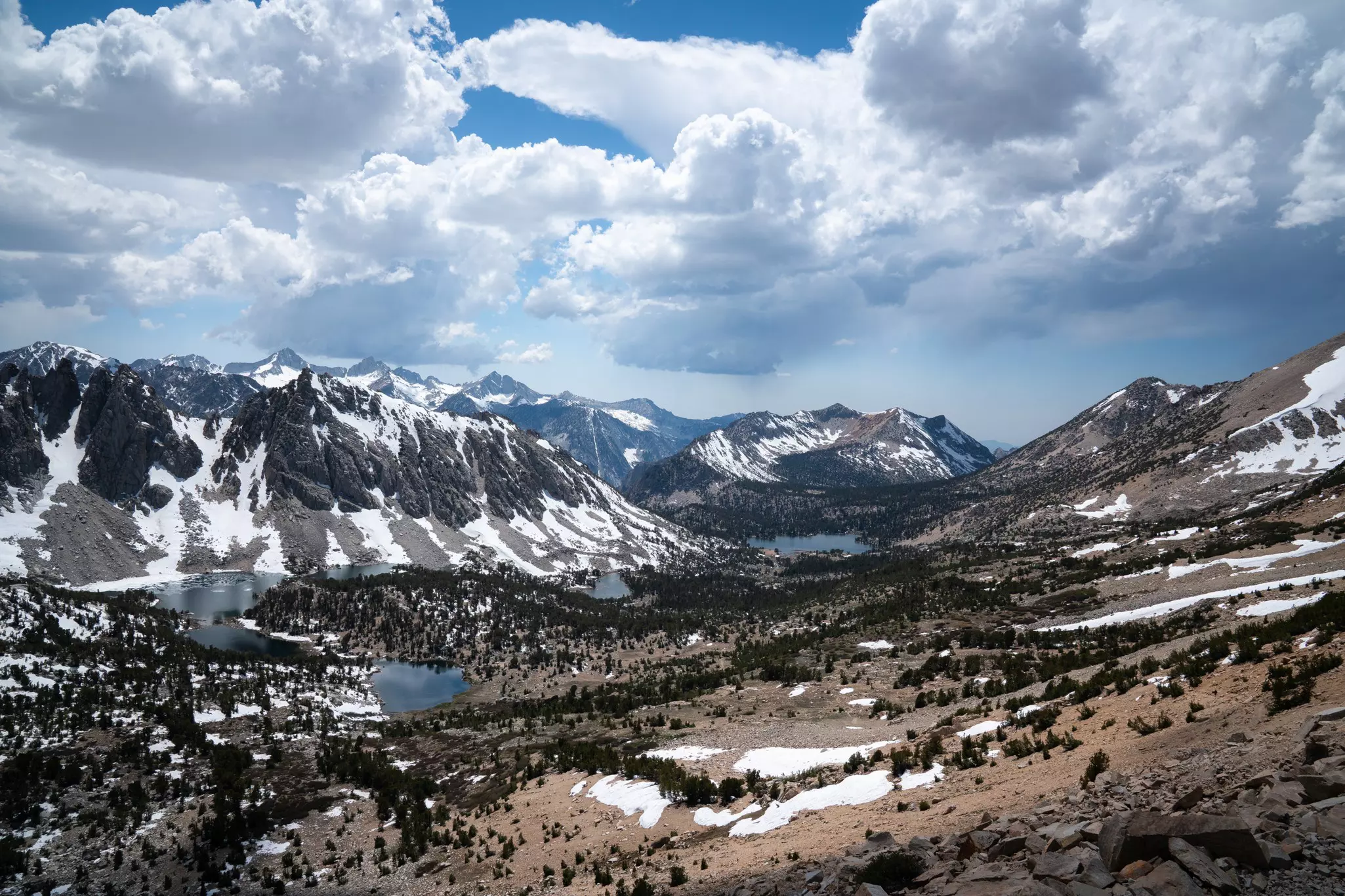 A mountain valley with lakes and woodland.