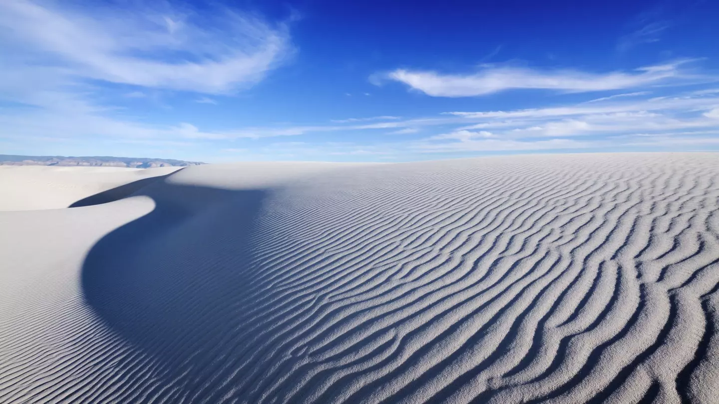 Tranquil image of sand dunes and beautiful blue sky, White Sands National Monument. sumikophoto / Shutterstock