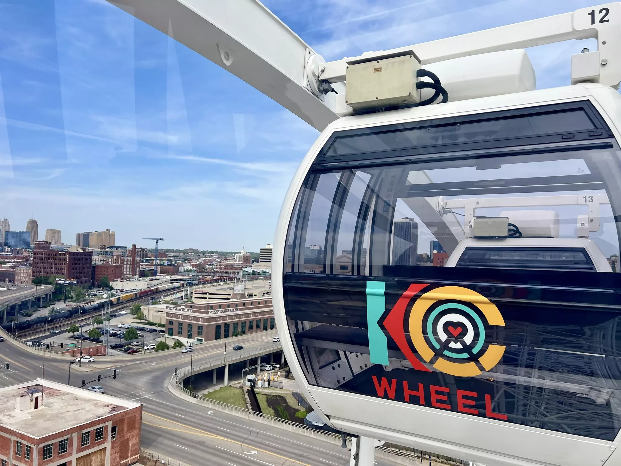 A city cable car carriage branded as "KC WHEEL"