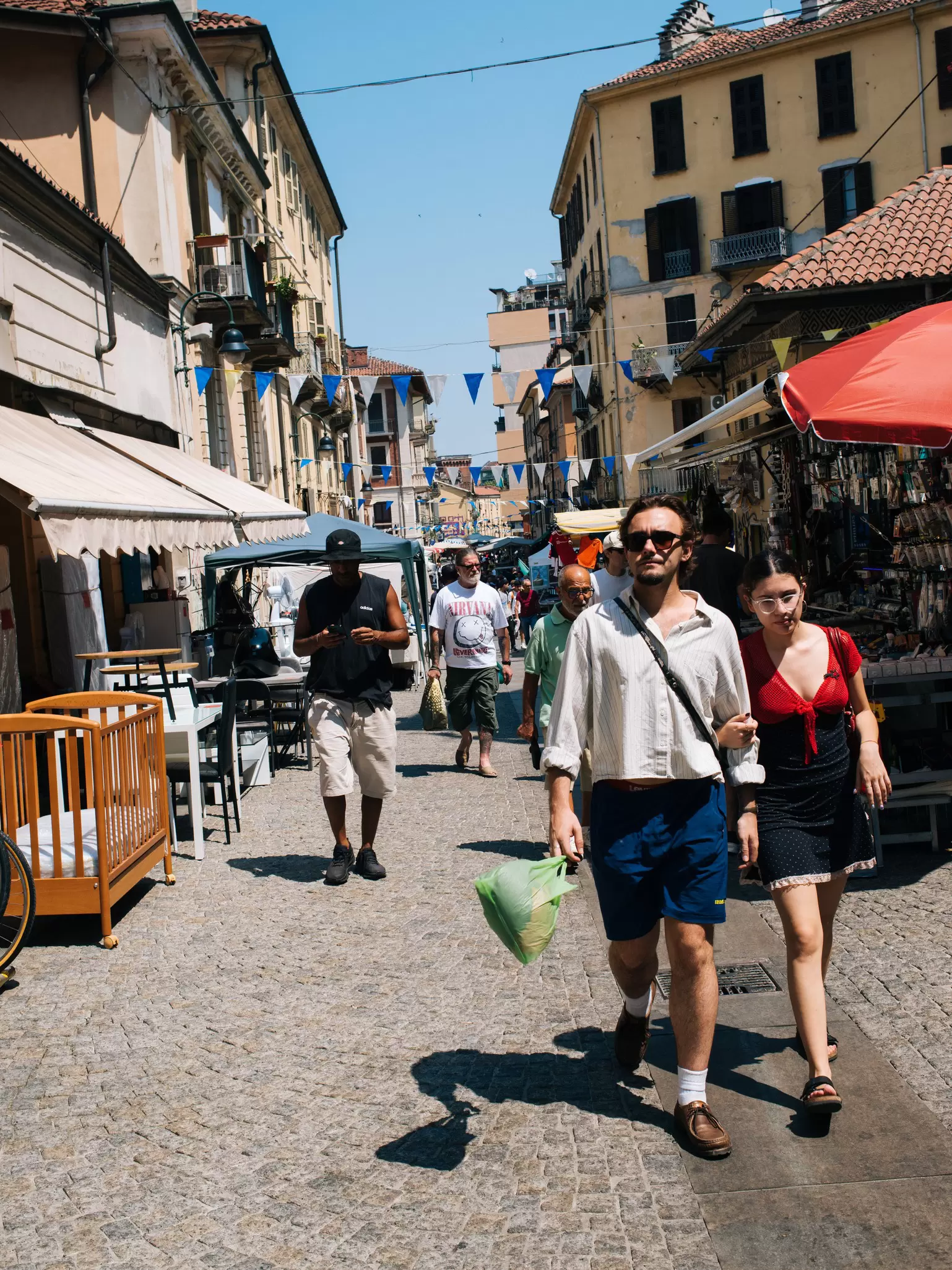 People walk through the streets around Mercato Balon in Turin. 
